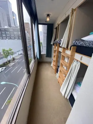 a dorm room with beds and a window at \u795e\u7530\u5927\u624b\u753a\u30db\u30b9\u30c6\u30eb in Tokyo