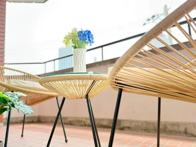 two chairs and a table with a vase of flowers at Ikebukuro 2Room D3 in Tokyo