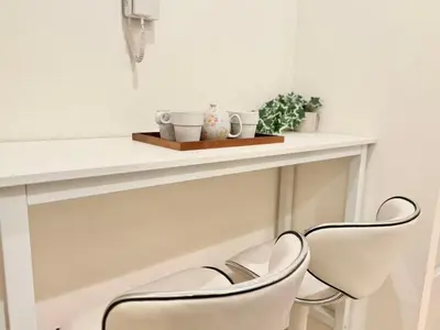 two white chairs sitting next to a white counter at Ikebukuro 2Room D3 in Tokyo