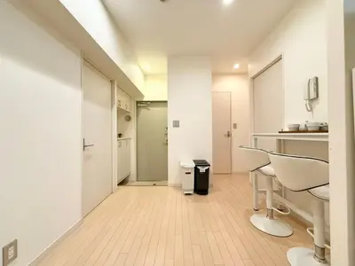 a kitchen with white walls and white tables and chairs at Ikebukuro 2Room D3 in Tokyo
