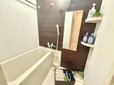 a bathroom with a tub and a sink and a mirror at Ikebukuro 2Room D3 in Tokyo