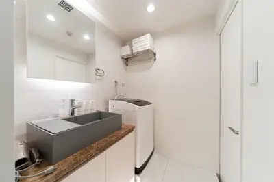 a small kitchen with a sink and a refrigerator at Brand New Luxury Suite 7 min to Omotesando 2 min to Shibuya in Tokyo