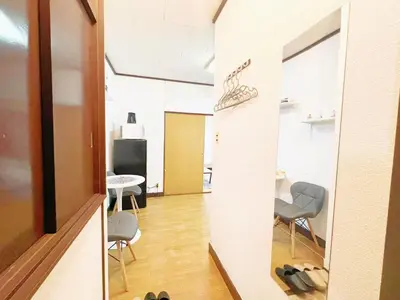 a hallway with chairs and a table in a room at Nogata Relaxing Home D2 in Tokyo