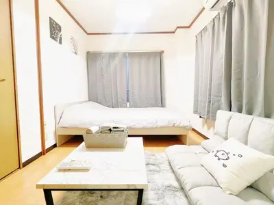a living room with a couch and a bed at Nogata Relaxing Home D2 in Tokyo