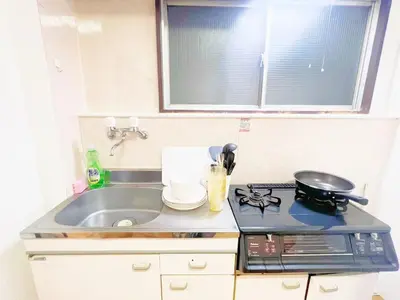 a kitchen counter with a sink and a stove at Nogata Relaxing Home D2 in Tokyo