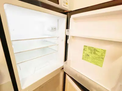 an open refrigerator with a sign on the door at Nogata Relaxing Home D2 in Tokyo