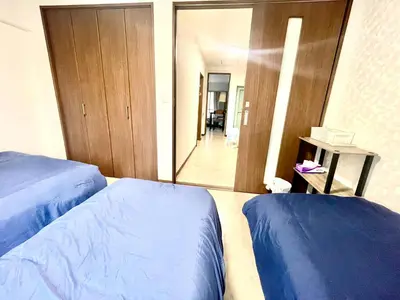 a bedroom with two beds and a large mirror at Tokyo Shinjuku Nishi-Waseda House Station 2mins in Tokyo