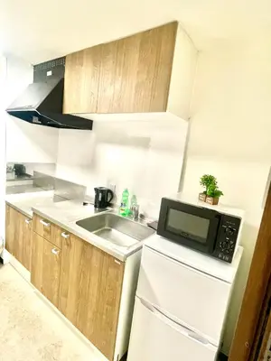a small kitchen with a sink and a microwave at Tokyo Shinjuku Nishi-Waseda House Station 2mins in Tokyo