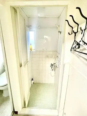 a small bathroom with a shower with a toilet at Tokyo Shinjuku Nishi-Waseda House Station 2mins in Tokyo