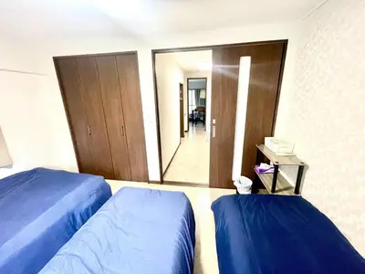 a hotel room with two beds and a mirror at Tokyo Shinjuku Nishi-Waseda House Station 2mins in Tokyo