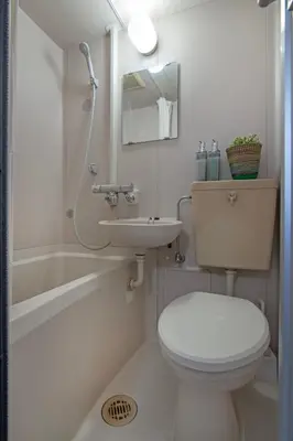 a white bathroom with a toilet and a sink at CraftFlat Numabukuro 301, uphill residence in Tokyo