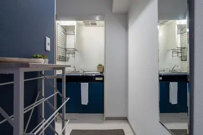 a bathroom with two sinks and blue cabinets at CraftFlat Numabukuro 301, uphill residence in Tokyo