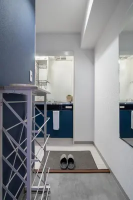 a room with a kitchen with blue cabinets and a ladder at CraftFlat Numabukuro 301, uphill residence in Tokyo