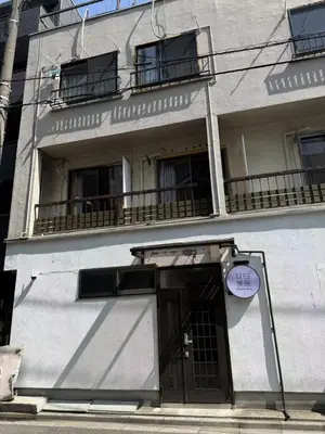 a building with a door with a sign on it at \u6d45\u8349\u82b1\u65e5\u7f8e\u5c45 Asakusa Hanichi 202 Queen Bed Room, 4 min walk to Asakusa Temple, direct subway access to Narita and Haneda Airport in Tokyo