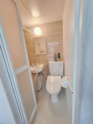a small bathroom with a toilet and a sink at \u6d45\u8349\u82b1\u65e5\u7f8e\u5c45 Asakusa Hanichi 202 Queen Bed Room, 4 min walk to Asakusa Temple, direct subway access to Narita and Haneda Airport in Tokyo