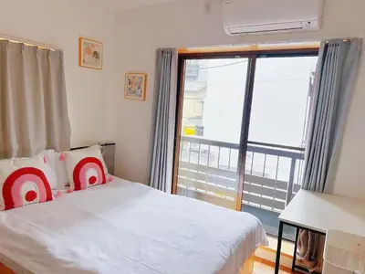a bedroom with a bed and a large window at \u6d45\u8349\u82b1\u65e5\u7f8e\u5c45 Asakusa Hanichi 202 Queen Bed Room, 4 min walk to Asakusa Temple, direct subway access to Narita and Haneda Airport in Tokyo