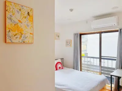 a small bedroom with a bed and a window at \u6d45\u8349\u82b1\u65e5\u7f8e\u5c45 Asakusa Hanichi 202 Queen Bed Room, 4 min walk to Asakusa Temple, direct subway access to Narita and Haneda Airport in Tokyo