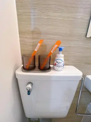 a toilet with two toothbrushes on top of it at \u6d45\u8349\u82b1\u65e5\u7f8e\u5c45 Asakusa Hanahi 305 Queen Bed Room, 4 min walk to Asakusa Temple, direct subway access to Narita and Haneda Airport in Tokyo