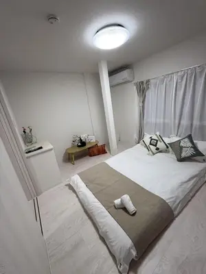 a bedroom with a large bed in a room with at Sogno House Tokyo Ueno in Tokyo