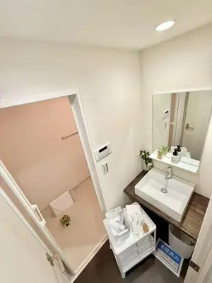 a bathroom with a sink and a mirror at Sogno House Tokyo Ueno in Tokyo