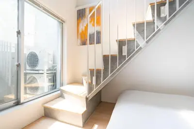 a staircase in a room with a window at PASEO\u5e02\u8c37\u53f0\u753al in Tokyo