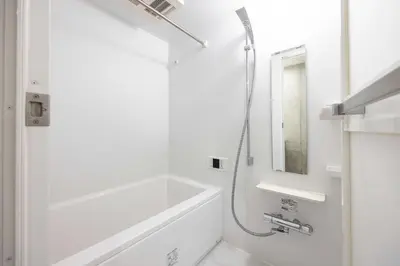 a white bathroom with a tub and a shower at PASEO\u5e02\u8c37\u53f0\u753al in Tokyo