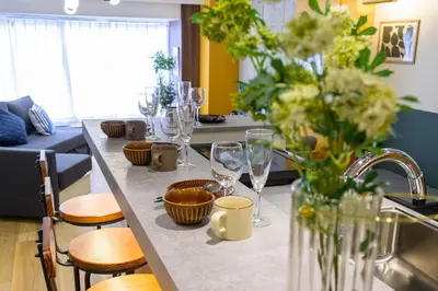a kitchen with a counter with wine glasses on it at TOMARU Meguro in Tokyo