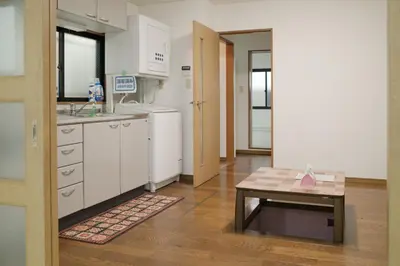 a kitchen with white cabinets and a table in it at \u5317\u533a\u99d2\u8fbc\u99c5 \u8fd1\u30a2\u30d1\u30fc\u30c8 \u6700\u592710\u540dstay OK in Tokyo