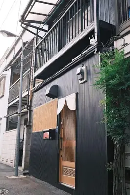 a building with a wooden door and a balcony at 1 stop in Ikebukuro,Direct access to Shinjuku,Shibuya,Tokyo Station and Tokyo Dome,Japanese-style single-family house,2-story detached house,MAX7 in Tokyo