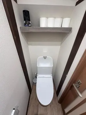 a toilet in a bathroom with a shelf with toilet paper at 1 stop in Ikebukuro,Direct access to Shinjuku,Shibuya,Tokyo Station and Tokyo Dome,Japanese-style single-family house,2-story detached house,MAX7 in Tokyo