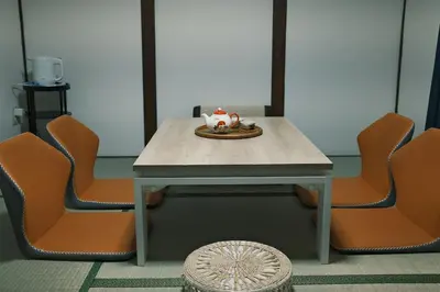 a table with orange chairs and a plate on it at 1 stop in Ikebukuro,Direct access to Shinjuku,Shibuya,Tokyo Station and Tokyo Dome,Japanese-style single-family house,2-story detached house,MAX7 in Tokyo