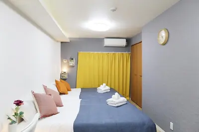 a hotel room with a bed with towels on it at M106 Easy access to Ikebukuro Red Leaves in Tokyo