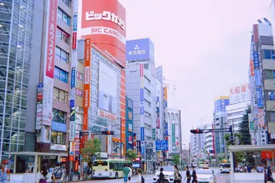 a busy city street with many tall buildings at M106 Easy access to Ikebukuro Red Leaves in Tokyo
