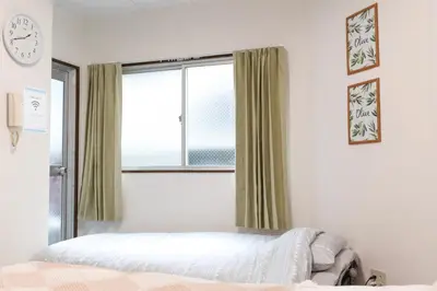 a bedroom with a bed and a window at Yoshiya in Tokyo
