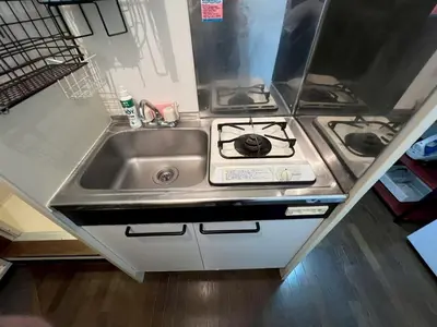 a kitchen with a sink and a stove at Yoshiya in Tokyo