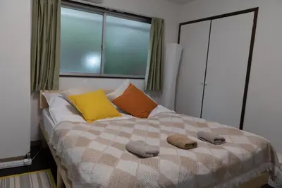 a bedroom with a bed with two towels on it at Yoshiya in Tokyo