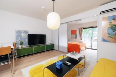 a living room with a bed and a tv at \u5bc5\u30db\u30c6\u30eb\u65b0\u6c5f\u53e4\u7530TORA HOTELShinEkoda in Tokyo