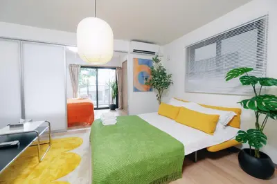a bedroom with a bed with a green rug at \u5bc5\u30db\u30c6\u30eb\u65b0\u6c5f\u53e4\u7530TORA HOTELShinEkoda in Tokyo