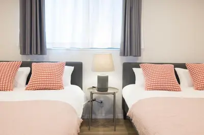 a bedroom with two beds and a lamp on a table at Senzoku, Taito City 101-TT0305 in Tokyo