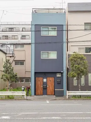 a blue building with wooden doors on a street at Senzoku, Taito City 101-TT0305 in Tokyo
