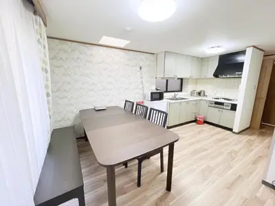 a kitchen with a table and chairs in a room at Shinjuku Homely House 4Rooms-D in Tokyo