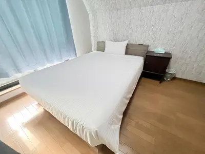 a white bed in a room with a window at Shinjuku Homely House 4Rooms-D in Tokyo