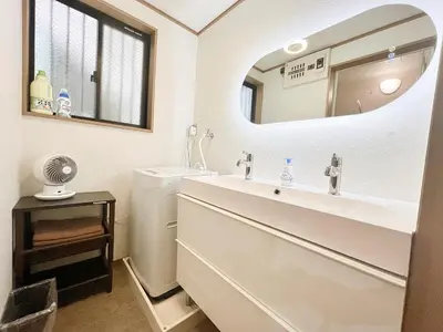 a bathroom with a sink and a mirror at Shinjuku Homely House 4Rooms-D in Tokyo
