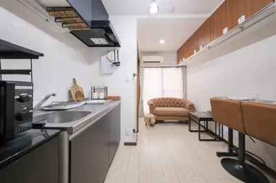 a kitchen with a sink and a couch in a room at Omo-Yado 20 minutes by car from Haneda Entire house in Tokyo