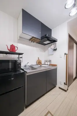 a kitchen with a sink and a microwave at Omo-Yado 20 minutes by car from Haneda Entire house in Tokyo