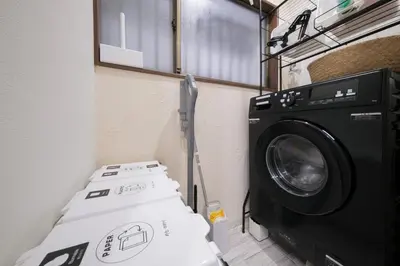 a laundry room with a washing machine and a washer at Omo-Yado 20 minutes by car from Haneda Entire house in Tokyo