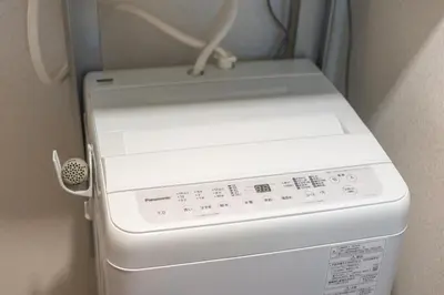 a white washer and dryer in a room at \u65b0\u5bbf\u6e0b\u8c37\u8fd1\u304f\u306b\u3042\u308b3\u5bdd\u5ba4105\u5e73\u7c73\u306e\u30a2\u30d1\u30fc\u30c8\u30e1\u30f3\u30c8 in Tokyo