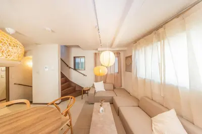 a living room with a couch and a table at Wooden house max 8 people 7 minutes walk to Skytree 75 square meters in Tokyo