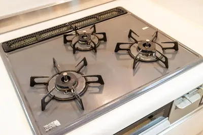 a stove top with three burners on top of it at Wooden house max 8 people 7 minutes walk to Skytree 75 square meters in Tokyo
