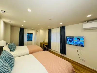 a hotel room with two beds and a flat screen tv at Senzoku, Taito City 201-TT0306 in Tokyo